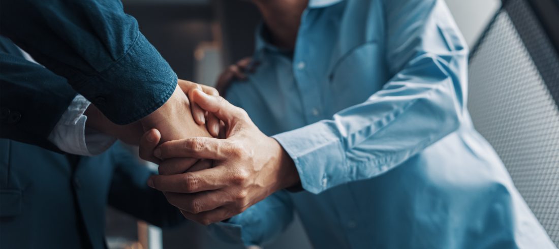 Local attorney shakes hands warmly with a happy client.