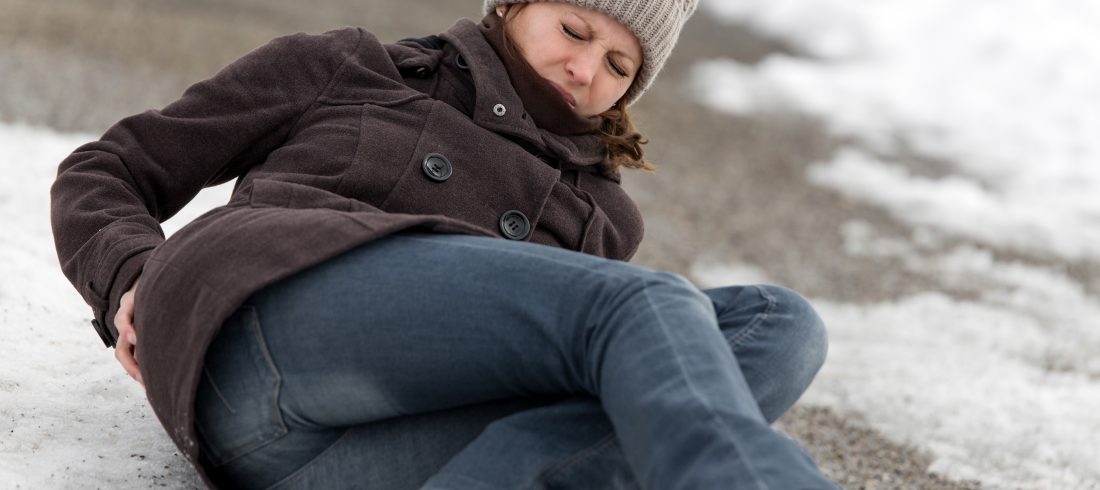 young woman has an accident on a icy way with black ice A young woman has an accident on an icy walkway in Michigan.
